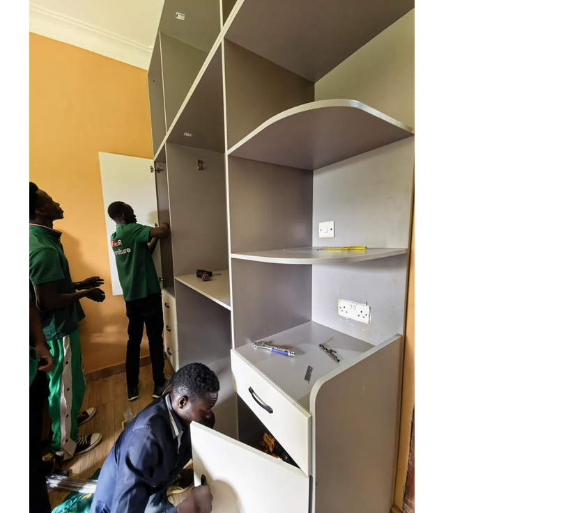 Uganda Doors Interior installation team mounting wardrobe hardware and shelving system in Kampala home