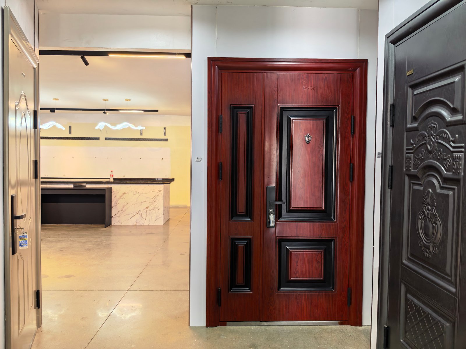 Premium carved wooden door with paint-free door samples in Uganda Doors Interior showroom Kampala