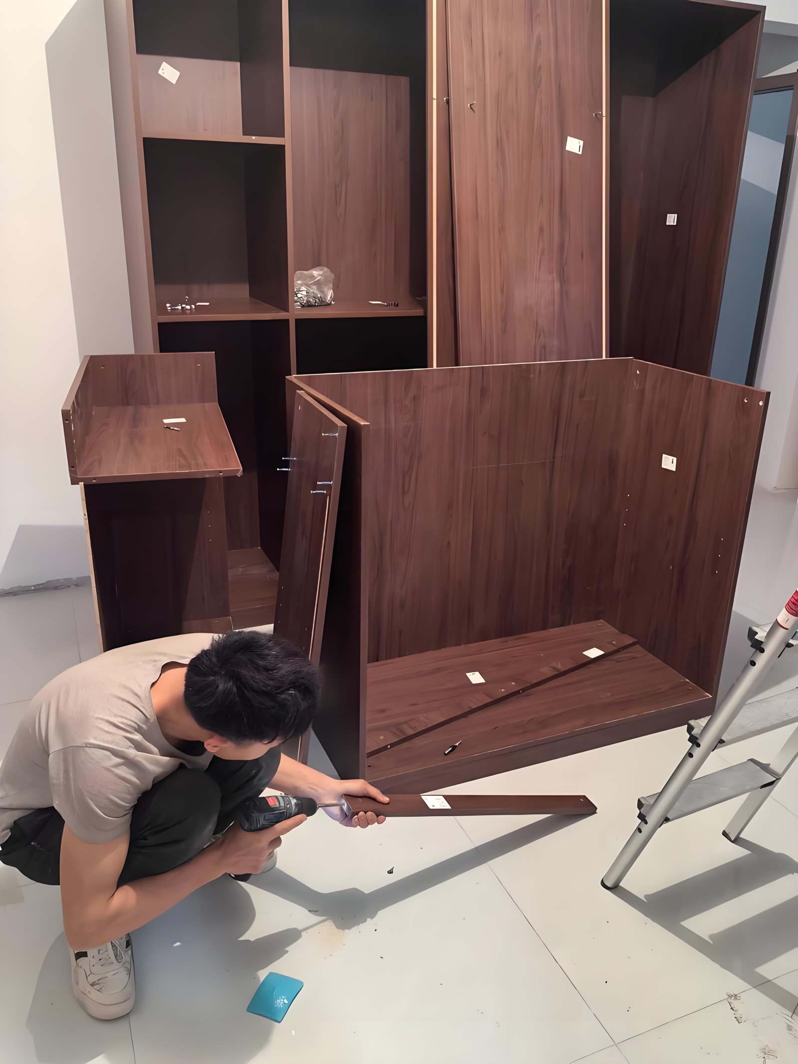 Professional furniture installer from Mr. Theo's Team assembling custom wardrobe at Uganda Doors Interior client site in Kampala